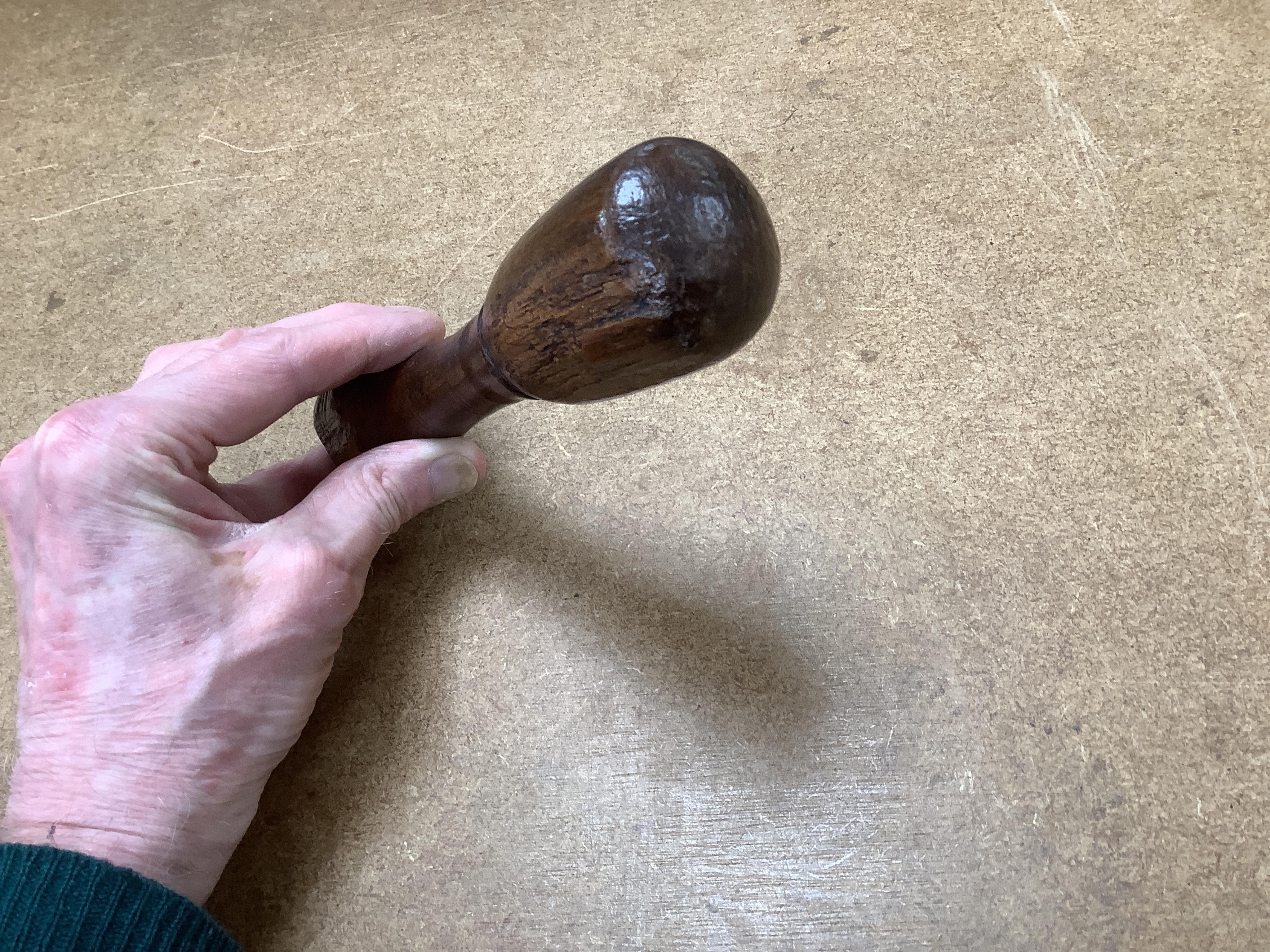 Sundry items to include a large pestle, spice grinder, flat iron on stand, bronze mortar and three other items, largest 42cm in length